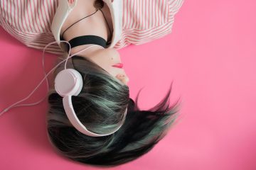 woman covering her hair and wearing headphones