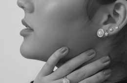grayscale photo of woman wearing silver diamond stud earrings