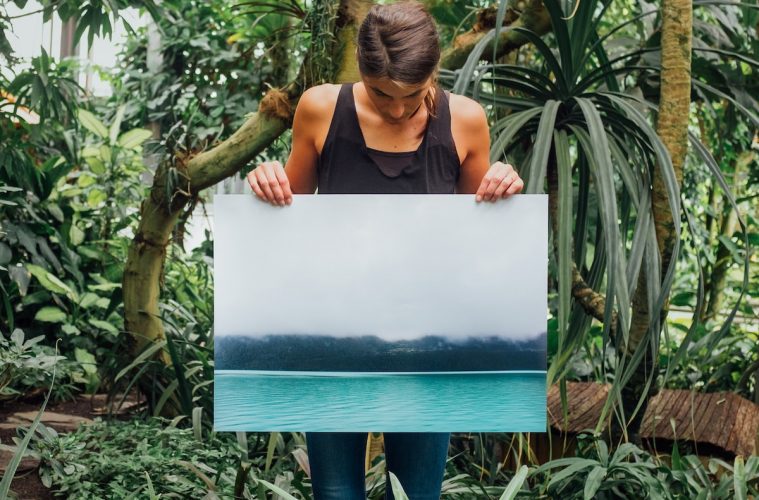 woman holding photo of tidal wave