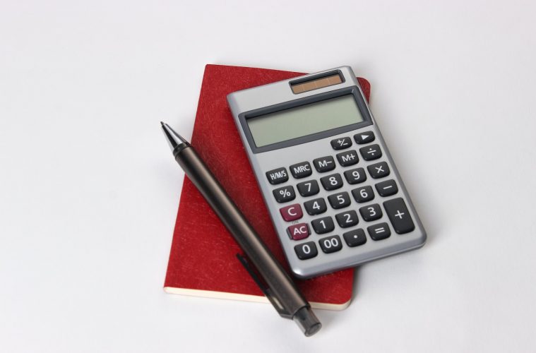black and silver calculator beside black pen