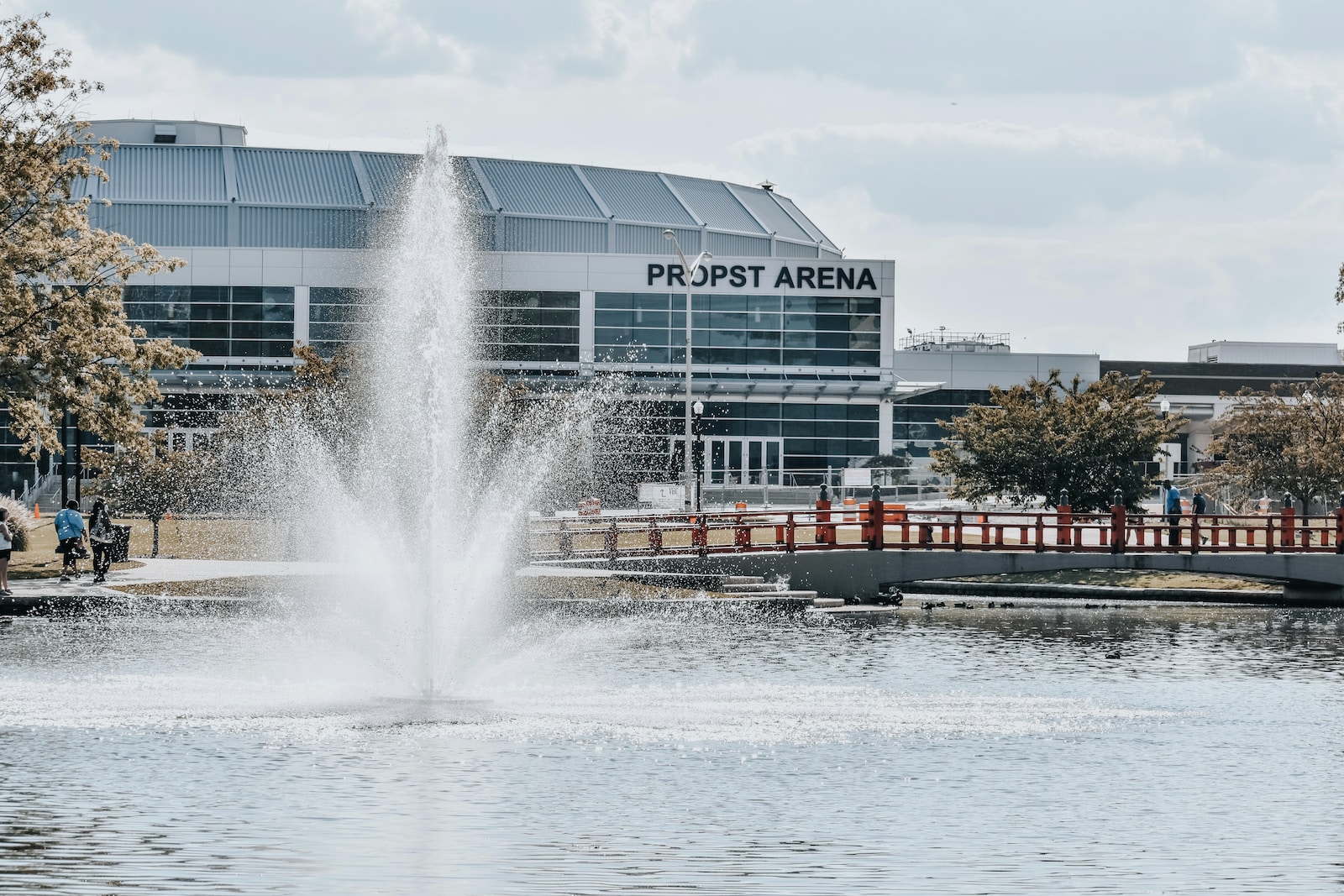 a water fountain in front of a large building