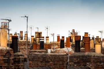a large group of chimneys on top of a brick building