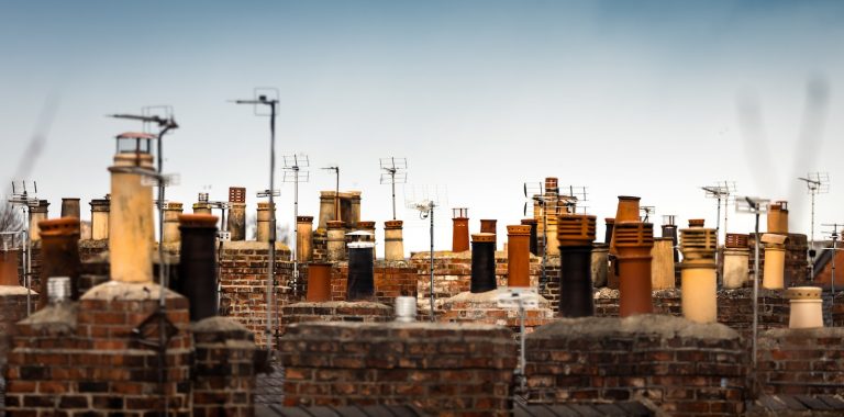 a large group of chimneys on top of a brick building