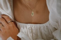 woman in white off shoulder dress wearing silver necklace