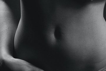 a black and white photo of a woman's stomach