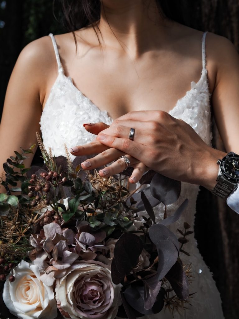 woman in white floral spaghetti strap top wearing silver ring