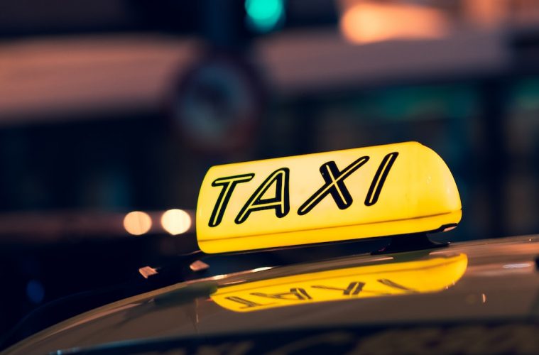 yellow taxi cab on road during night time