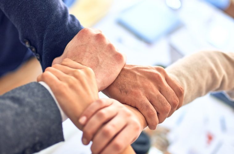 person in black long sleeve shirt holding persons hand