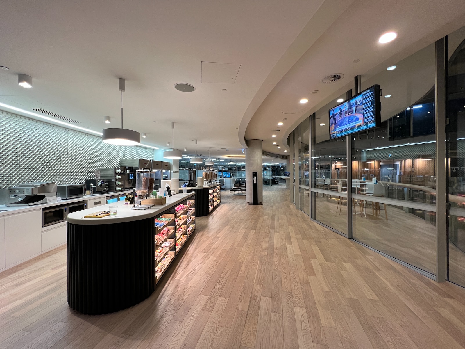 a large room with a large glass wall and a tv on the wall