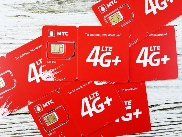 a group of red sim cards sitting on top of a wooden table