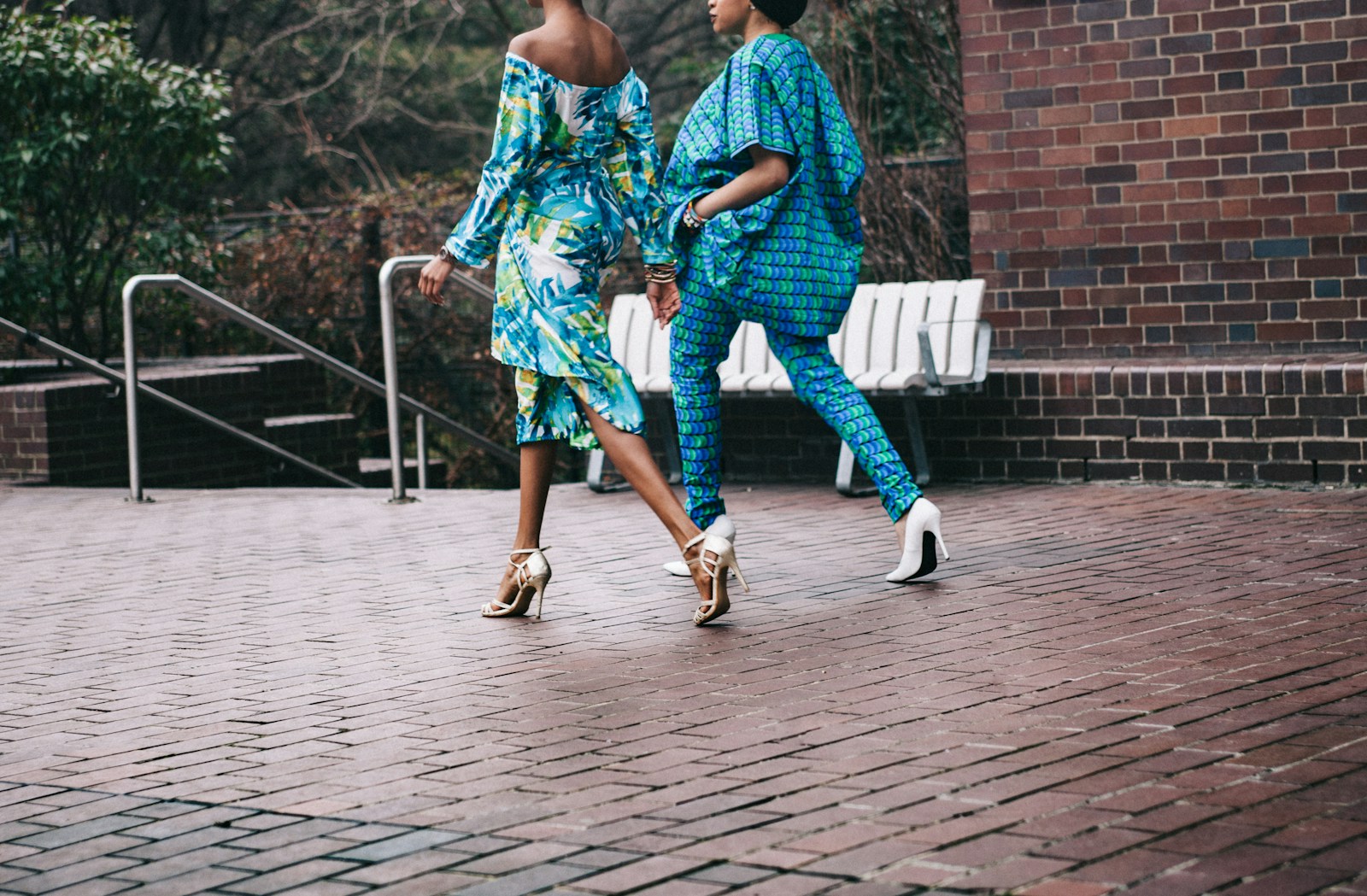 two women in teal romper pants