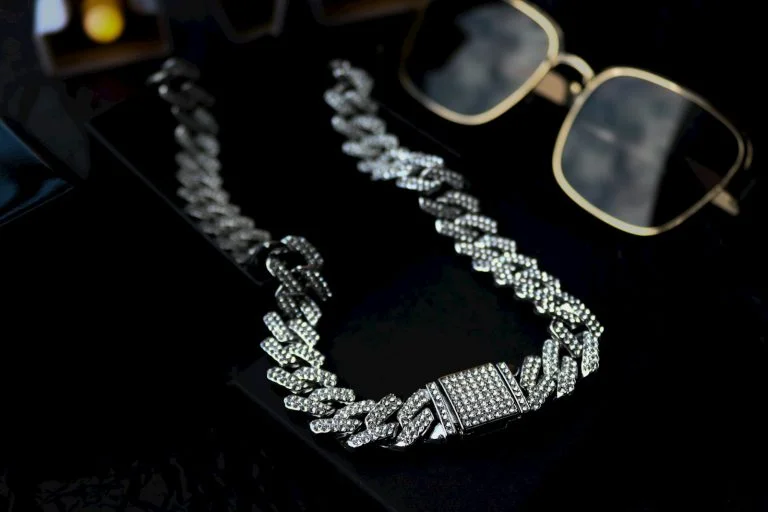 A pair of glasses and a necklace on a table